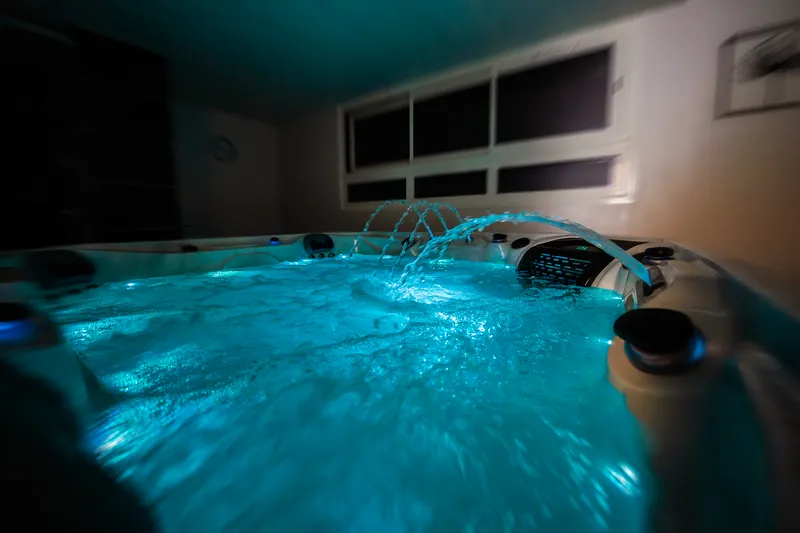 Spa de nage en fonctionnement : nage à contre-courant, cascades et éclairage LED